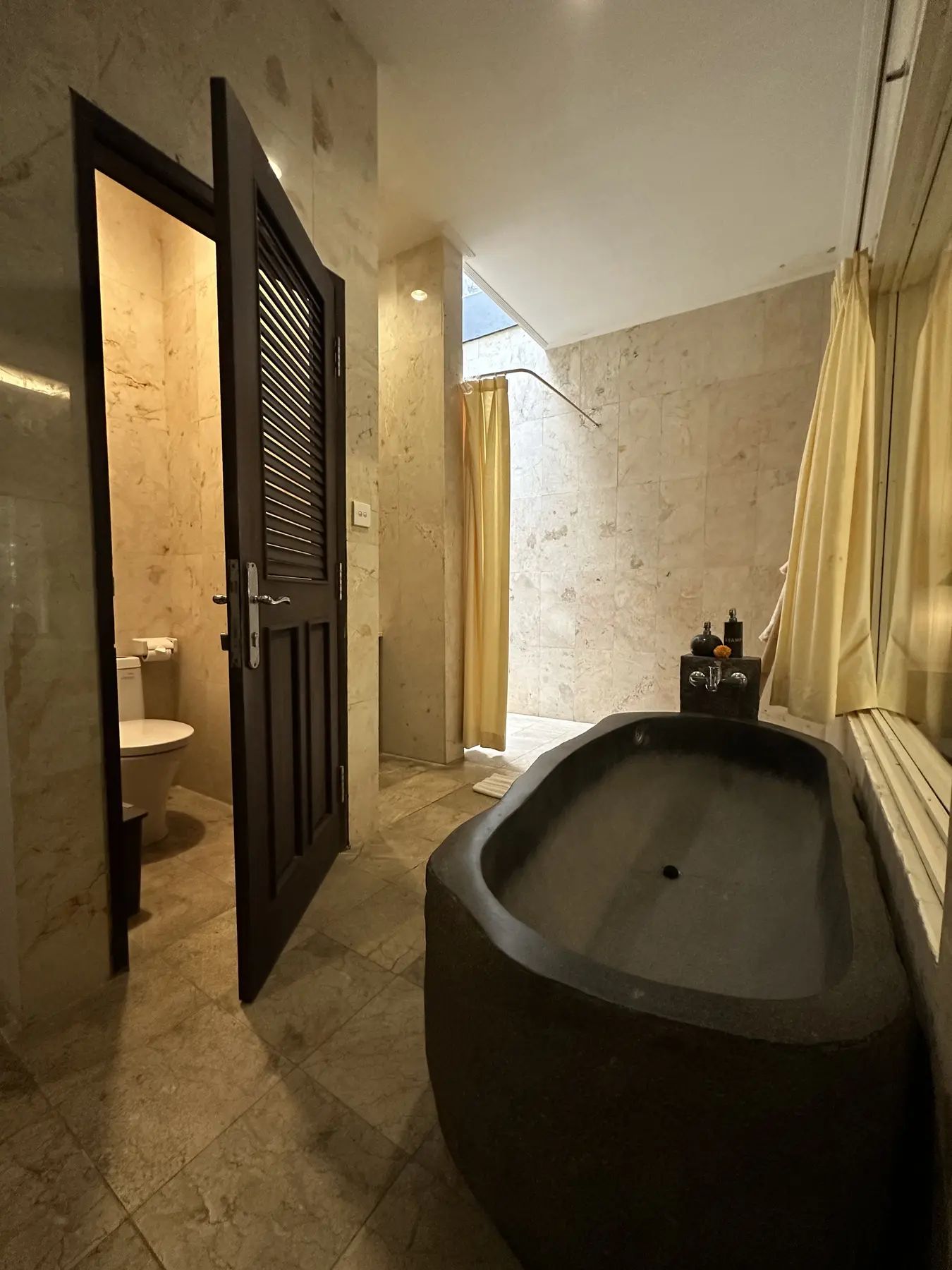 Freestanding stone bathtub and shower in the Junior Suite bathroom